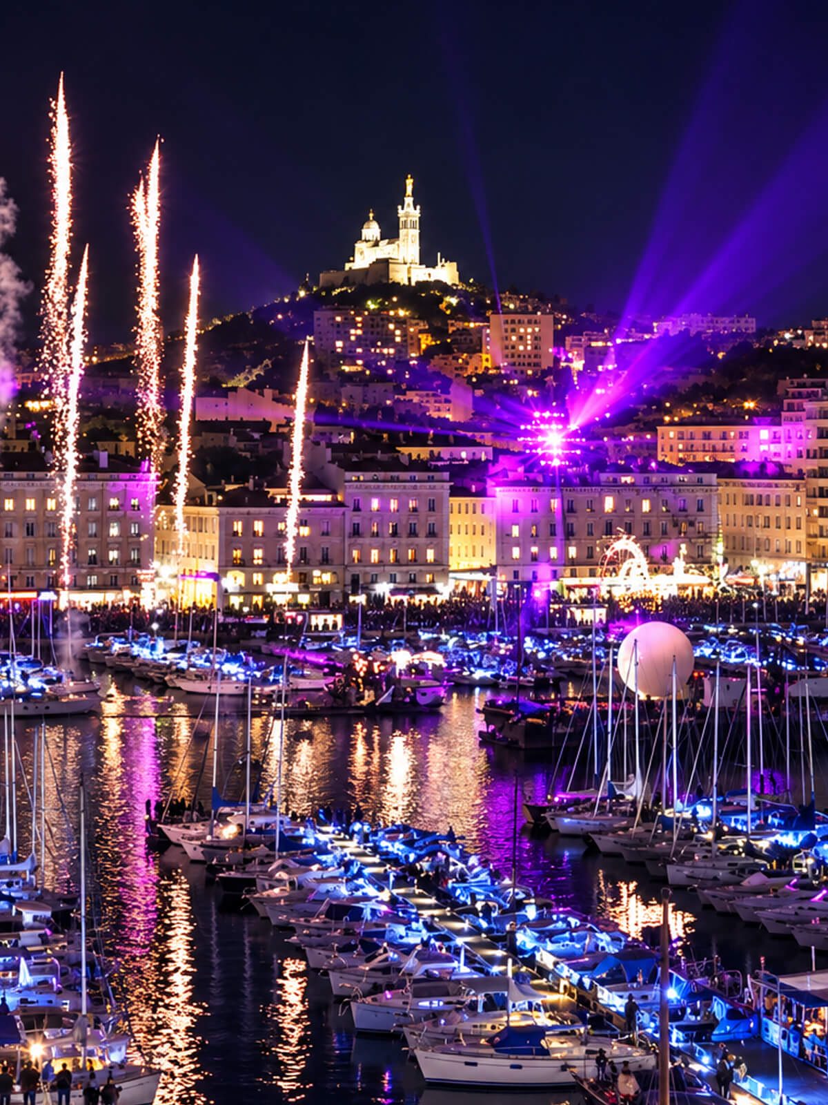 Feu dâartifice et faisceaux lumineux au-dessus du Vieux-Port, la nuit, Notre-Dame illuminĂ©e