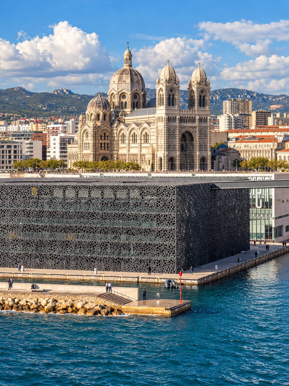 Le Mucem et sa rĂ©sille de bĂ©ton au bord de lâeau, la cathĂ©drale de la Major en arriĂšre-plan